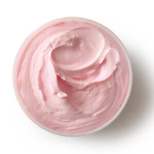 Jar of pink cosmetic cream body butter isolated on white background, top view