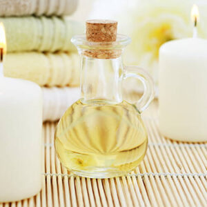 Massage oil with candles and towels beauty treatment