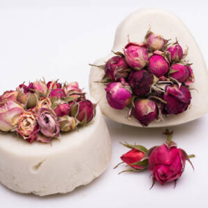 Soap handmade with roses on a white background.
