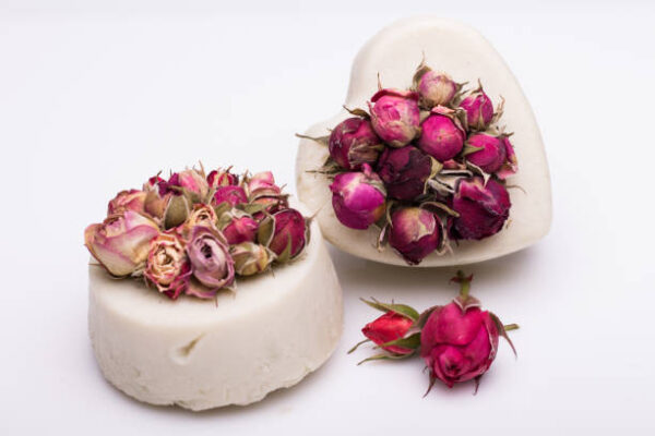 Soap handmade with roses on a white background.